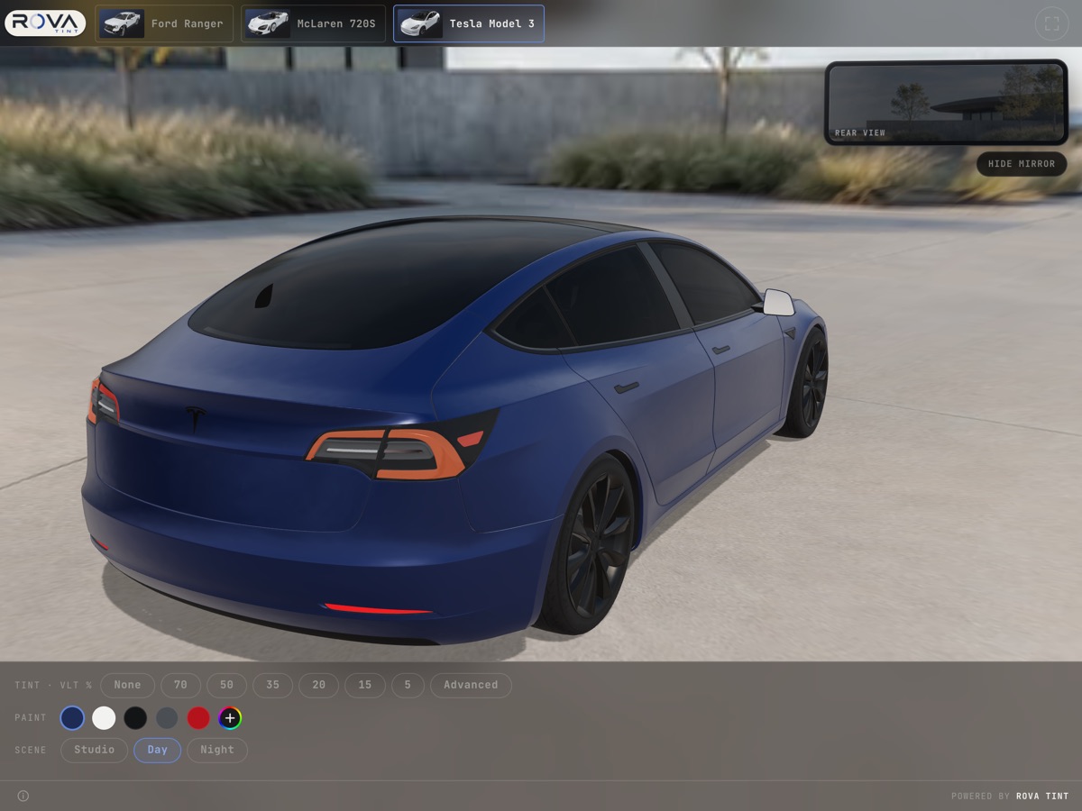 The live rear-view mirror showing the view through the tinted back glass of the Tesla Model 3